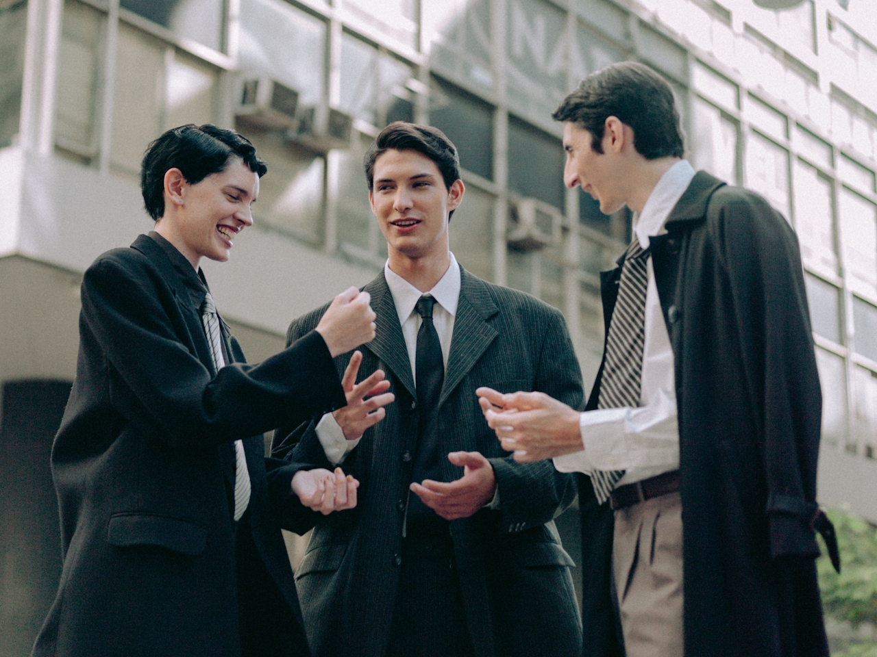 Three professionals engaged in a conversation